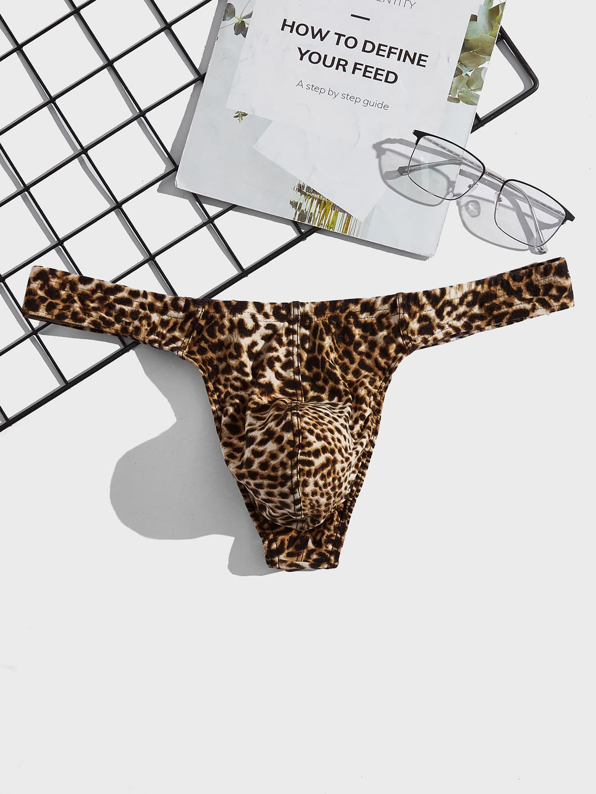 Men's leopard print thong underwear featuring a low-rise fit and high-stretch multicolor fabric.