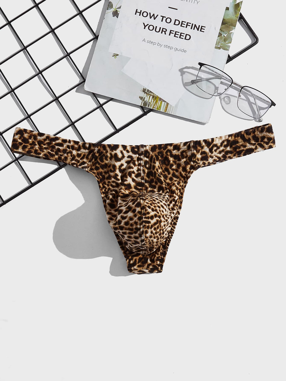 Men's leopard print thong underwear featuring a low-rise fit and high-stretch multicolor fabric.