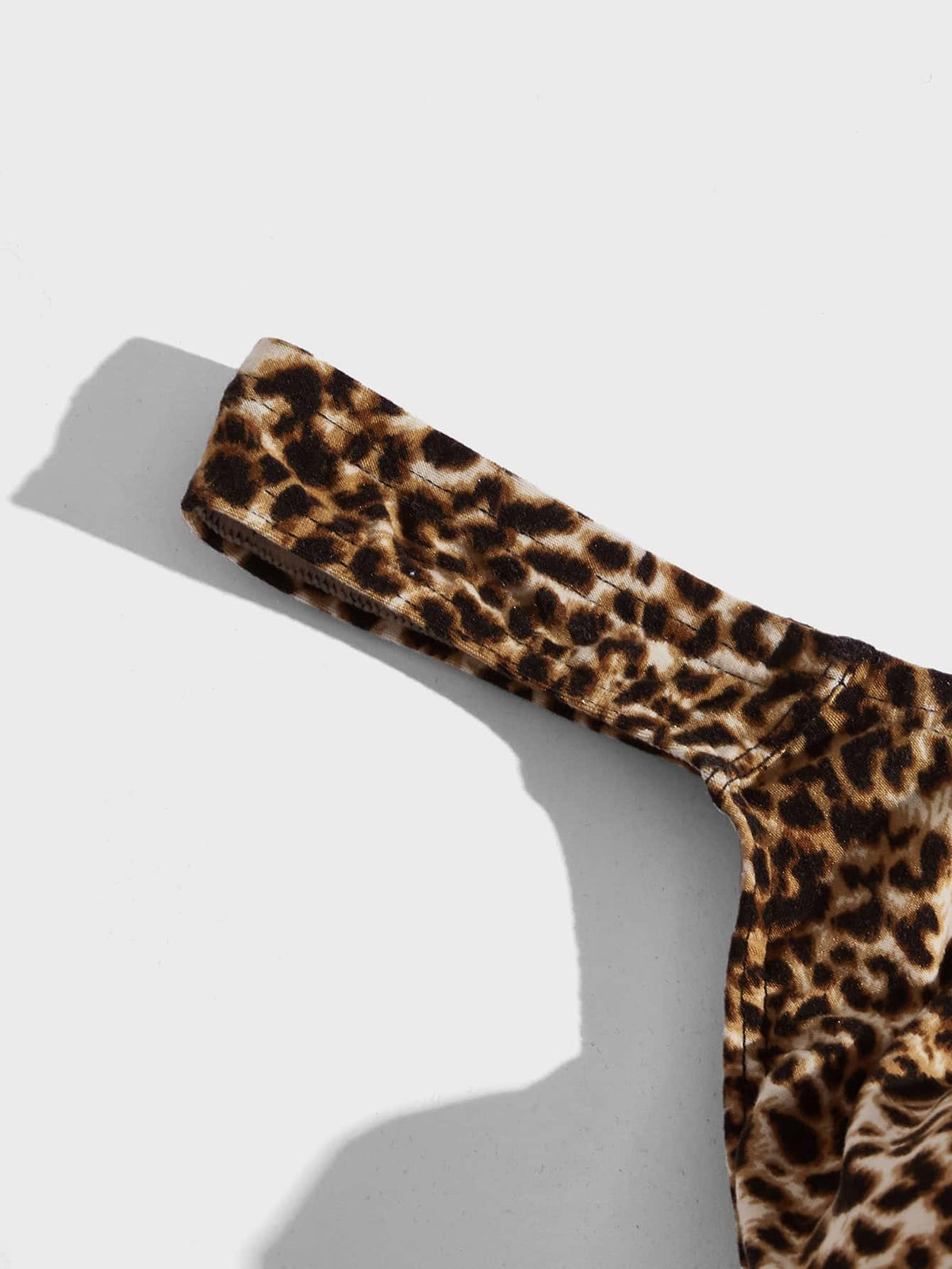 Men's leopard print thong underwear featuring a low-rise fit and high-stretch multicolor fabric.