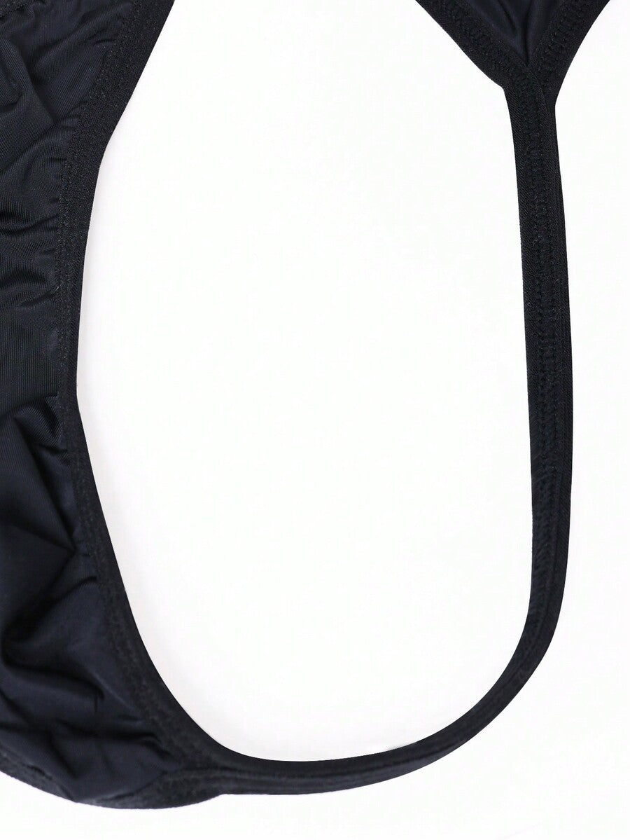 Men's black knitted fabric low-rise thong underwear featuring knot detail.