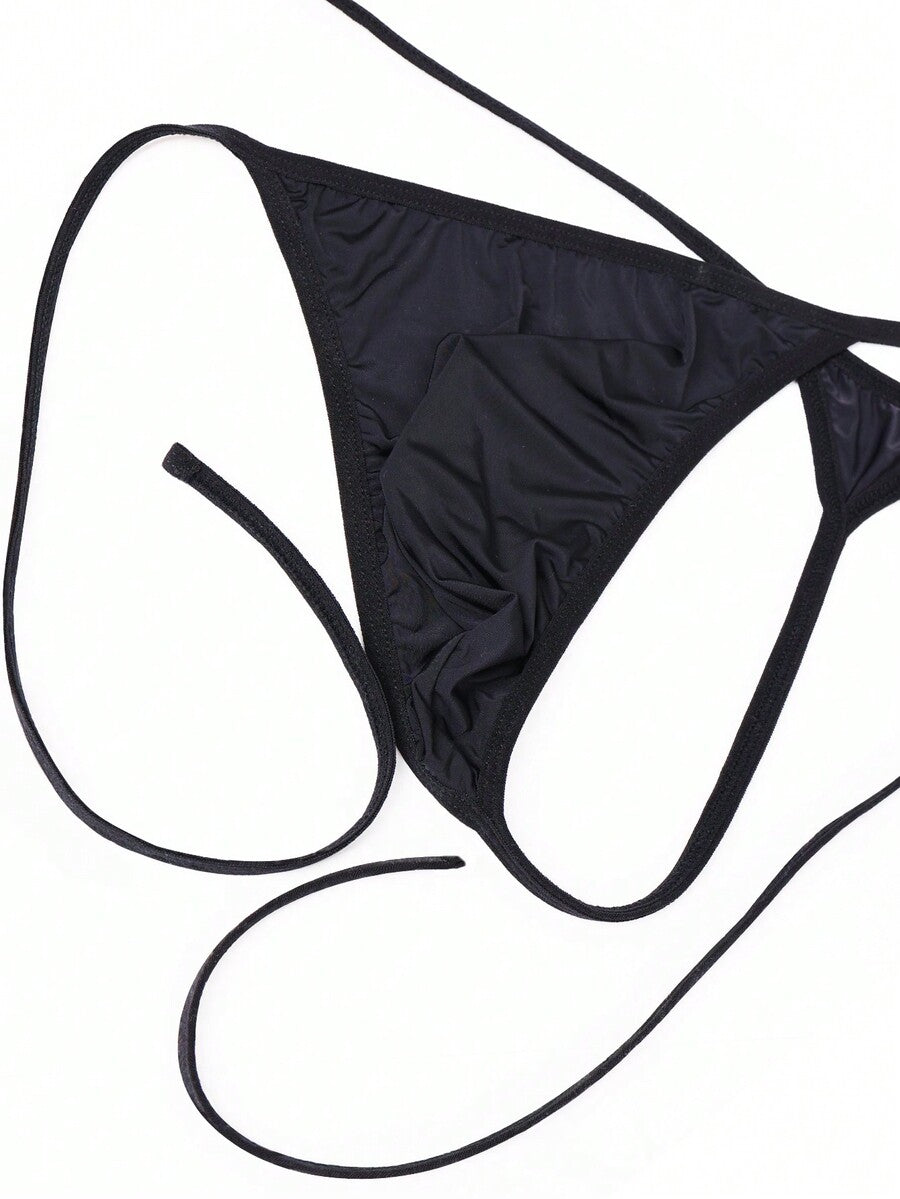 Men's black knitted fabric low-rise thong underwear featuring knot detail.