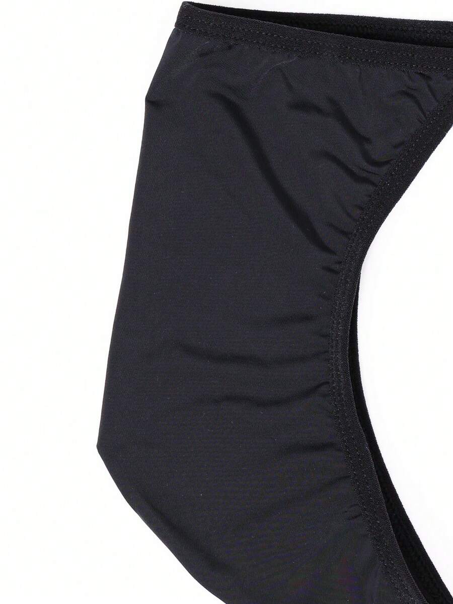 Men's black knitted fabric low-rise thong underwear featuring knot detail.