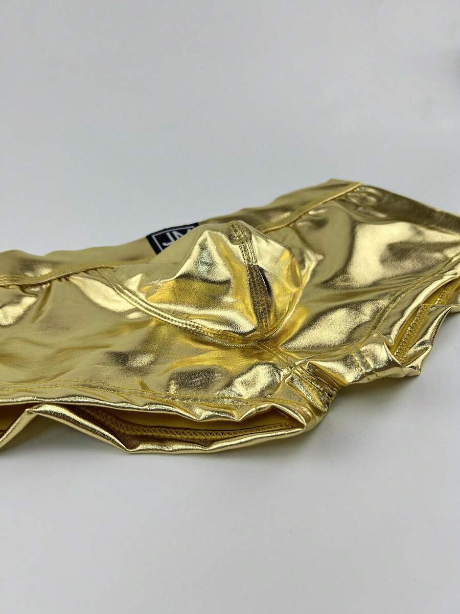 Gold men's glossy stage reflective faux leather trunks featuring mid-rise waistband and stretch fabric.