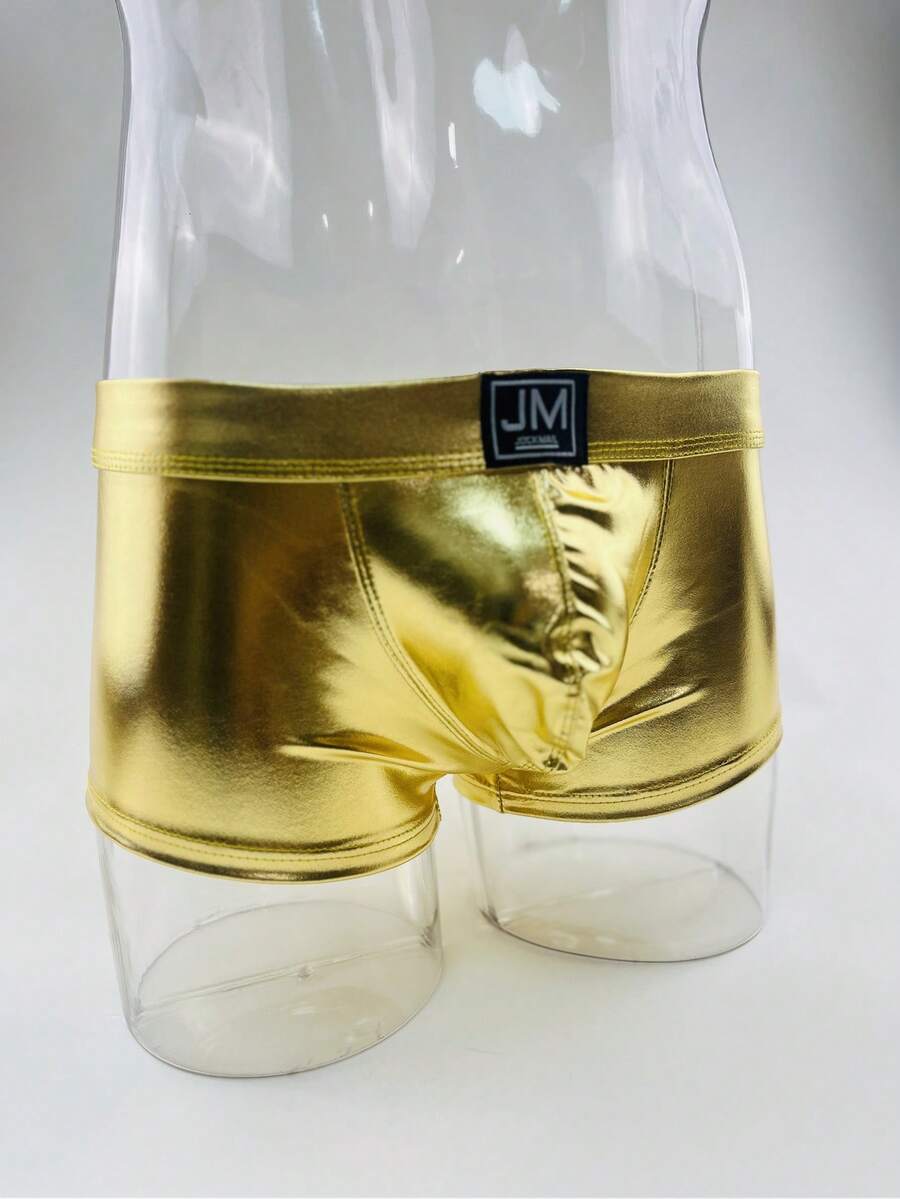 Gold men's glossy stage reflective faux leather trunks featuring mid-rise waistband and stretch fabric.