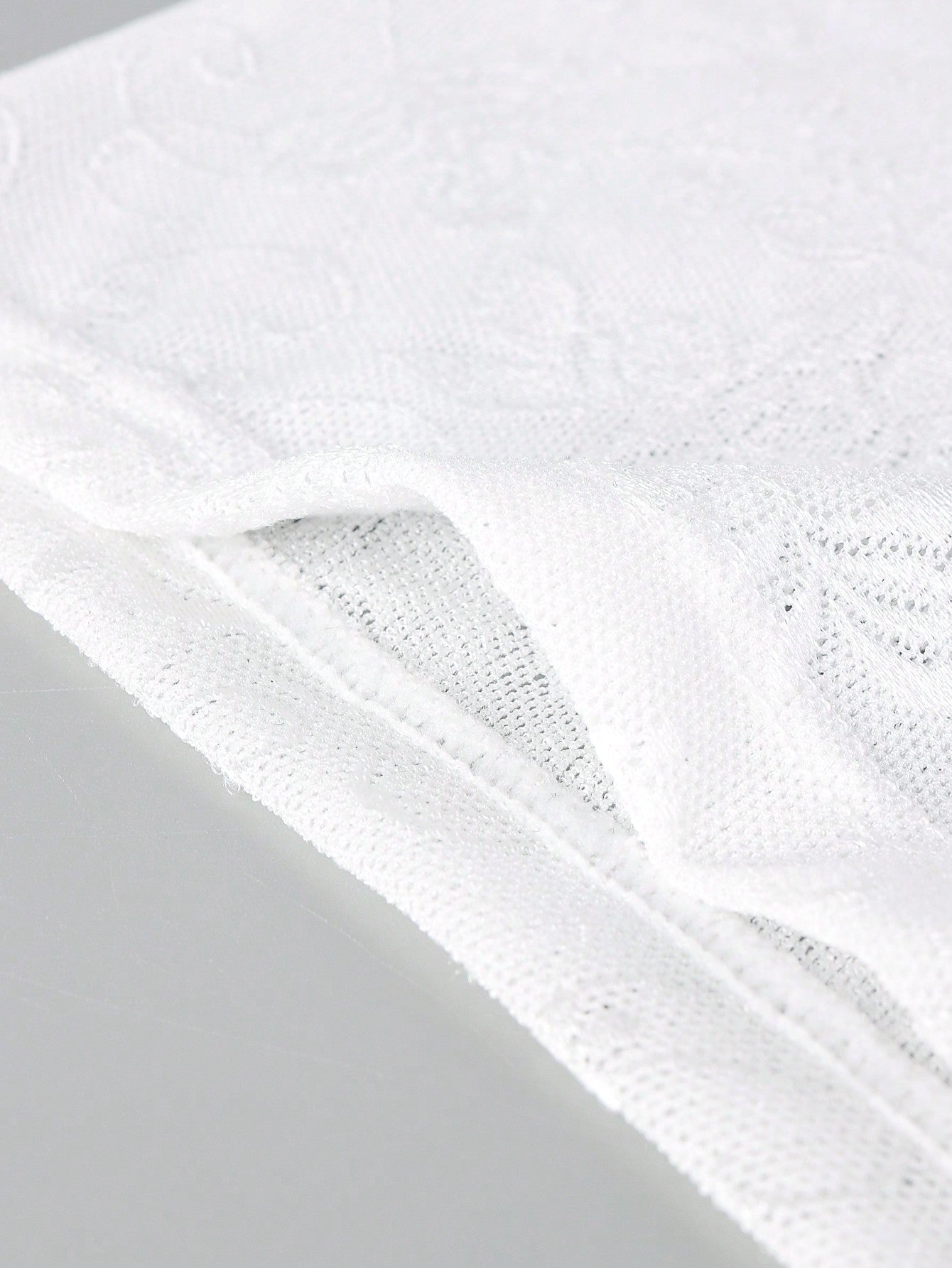White men's low rise boxer shorts with mesh fabric and patchwork detail, short length, medium stretch, made from polyamide and elastane.