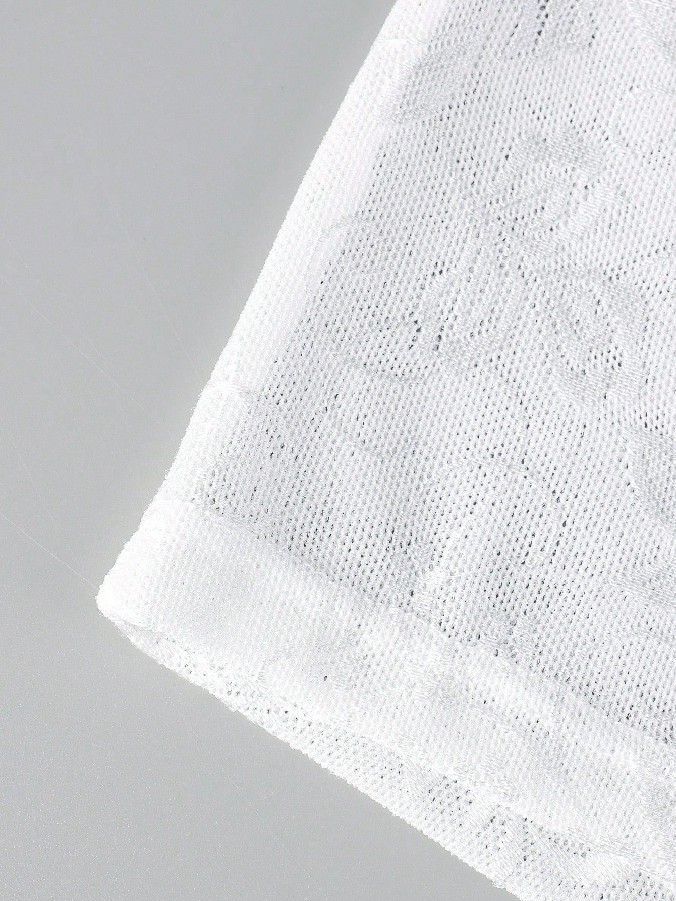 White men's low rise boxer shorts with mesh fabric and patchwork detail, short length, medium stretch, made from polyamide and elastane.
