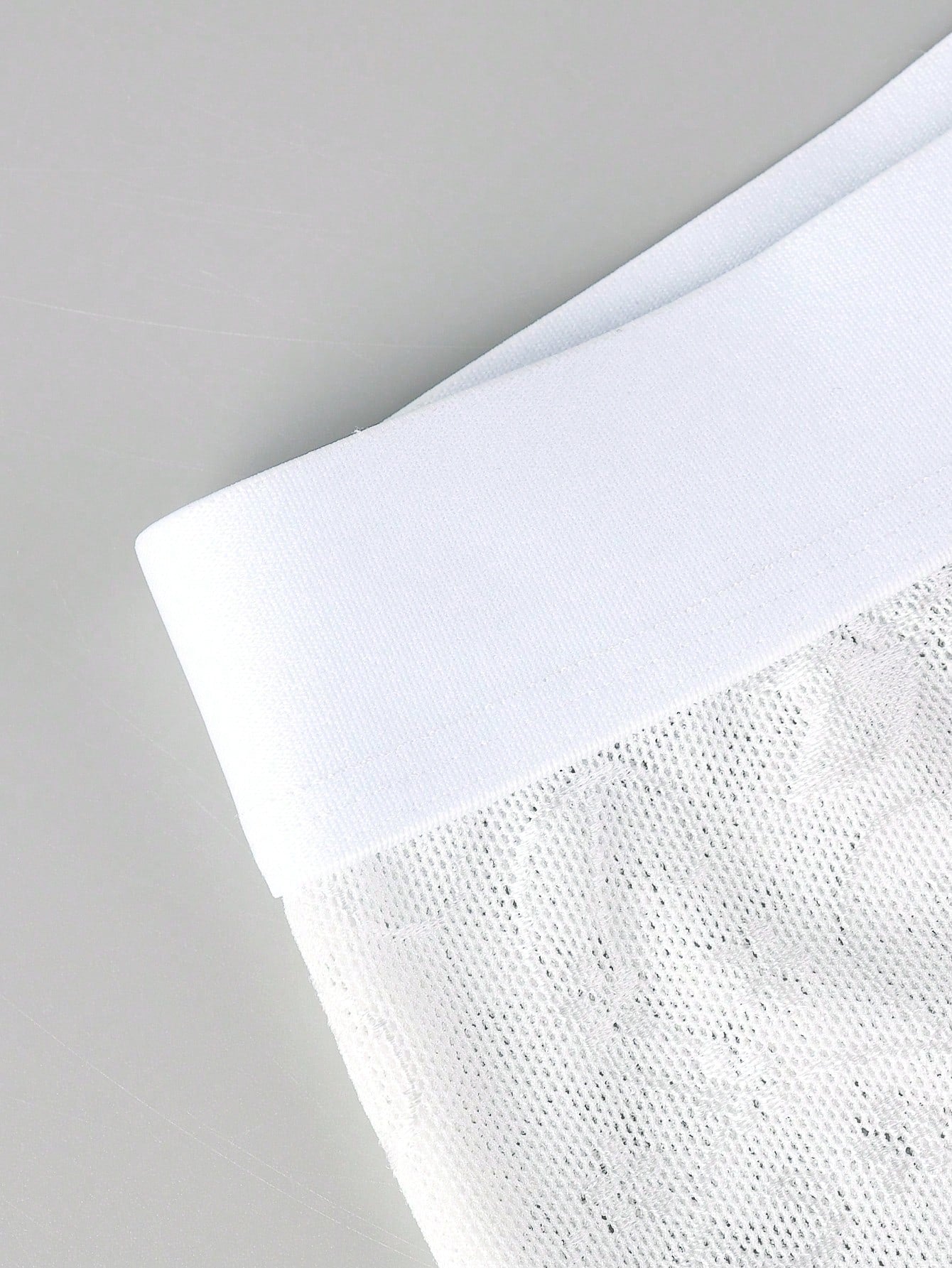 White men's low rise boxer shorts with mesh fabric and patchwork detail, short length, medium stretch, made from polyamide and elastane.