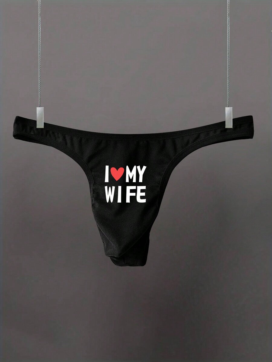 Black low-rise men's thong underwear with letter print pattern made of knitted fabric.
