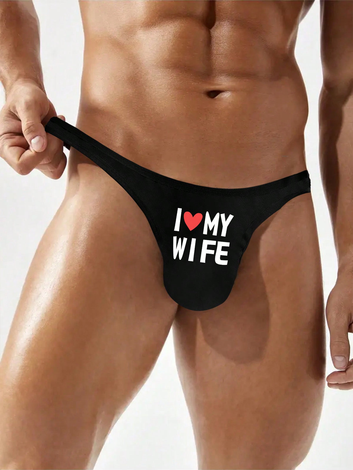 Black low-rise men's thong underwear with letter print pattern made of knitted fabric.