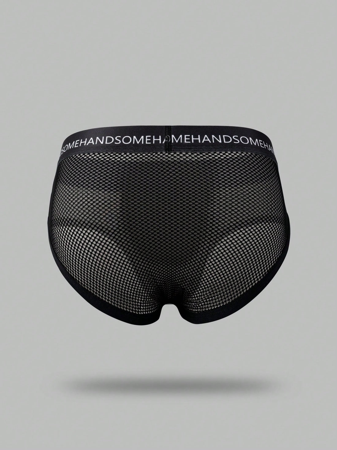 Black men's low rise briefs with cut out detail, letter elastic waistband, and medium-stretch knitted polyamide blend.