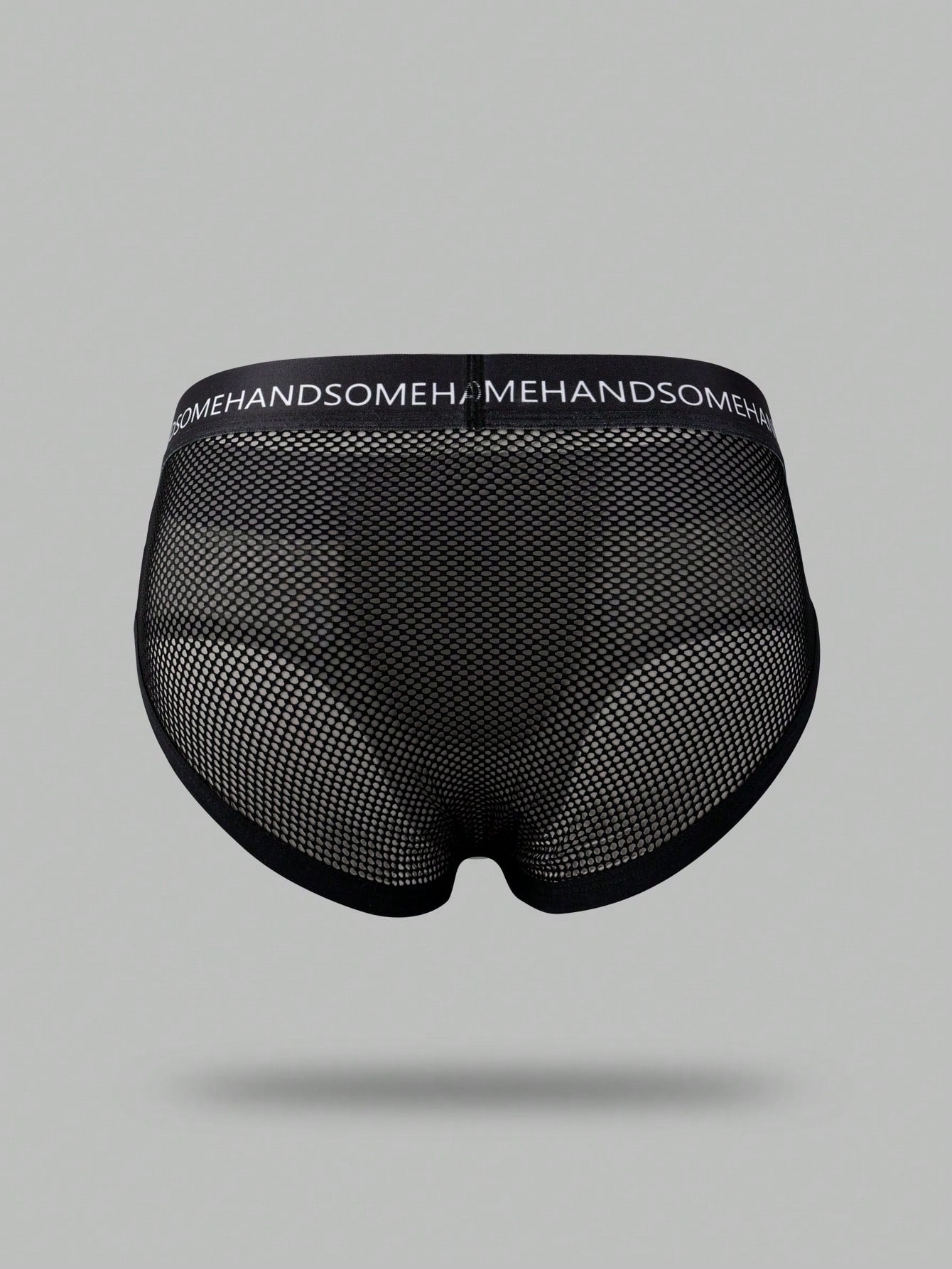 Black men's low rise briefs with cut out detail, letter elastic waistband, and medium-stretch knitted polyamide blend.