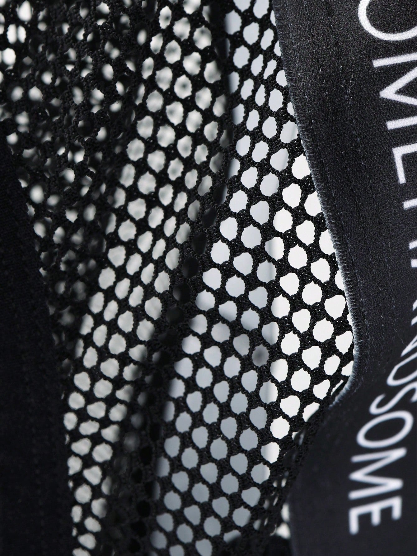 Black men's low rise briefs with cut out detail, letter elastic waistband, and medium-stretch knitted polyamide blend.
