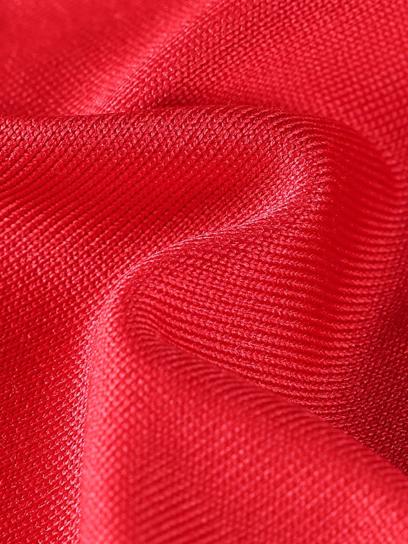 Red men's low rise thong underwear with lace panel, cut-out detail, and medium stretch knitted fabric.