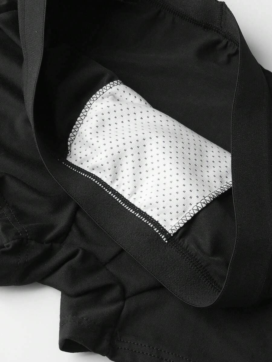 Two pairs of men's black graphic briefs with mid-rise waist, colorblock design, and high stretch fabric.