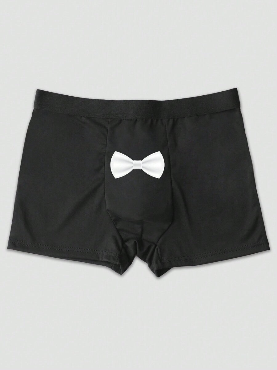Two pairs of men's black graphic briefs with mid-rise waist, colorblock design, and high stretch fabric.