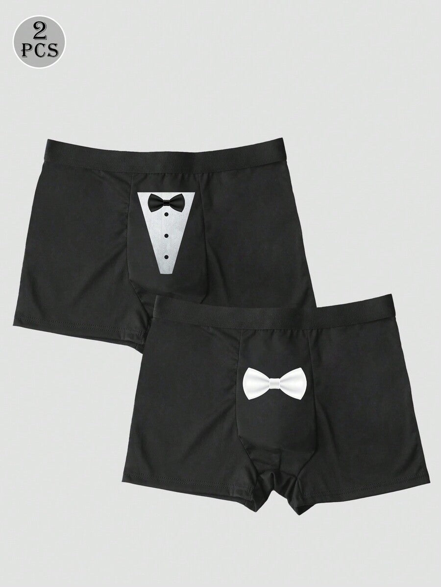 Two pairs of men's black graphic briefs with mid-rise waist, colorblock design, and high stretch fabric.