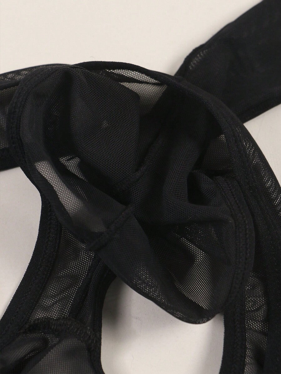 Black semi-sheer mesh thong underwear for men featuring a heart eye print pattern and low-rise fit.