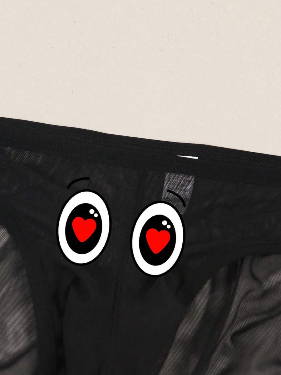 Black semi-sheer mesh thong underwear for men featuring a heart eye print pattern and low-rise fit.