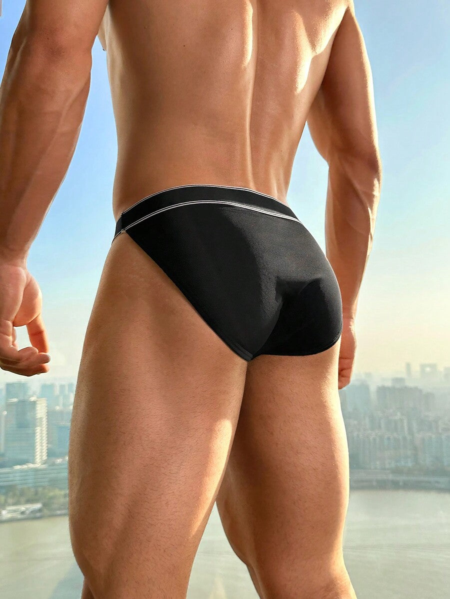 Black men's low rise boxer briefs featuring contrast binding detail and tape trim.