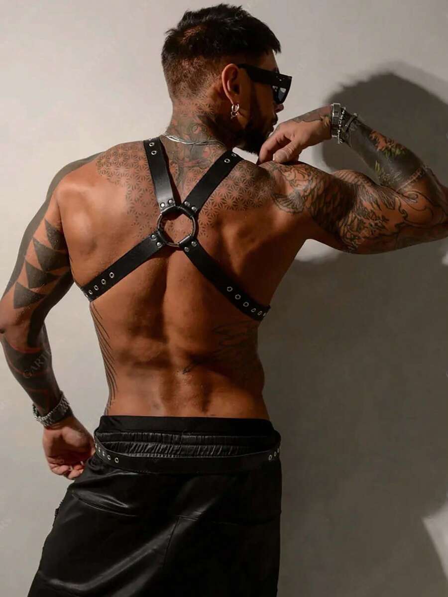 Black PU leather chest harness for men with adjustable straps, rivet details, and a metal O-ring back design.