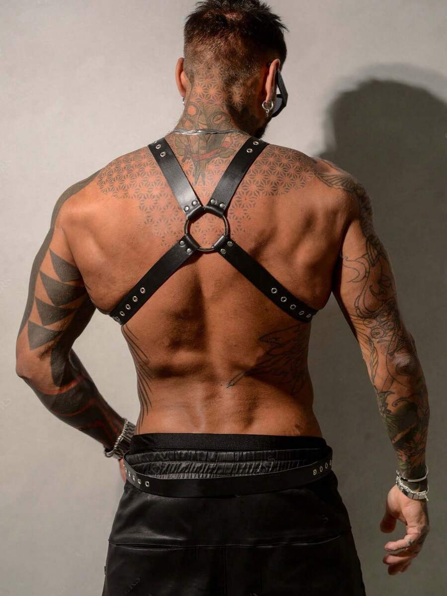 Black PU leather chest harness for men with adjustable straps, rivet details, and a metal O-ring back design.