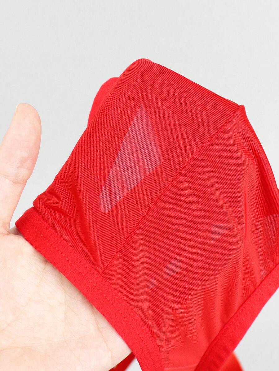 Red men's low-rise jockstrap underwear featuring criss-cross cut-out details in medium stretch knitted fabric.