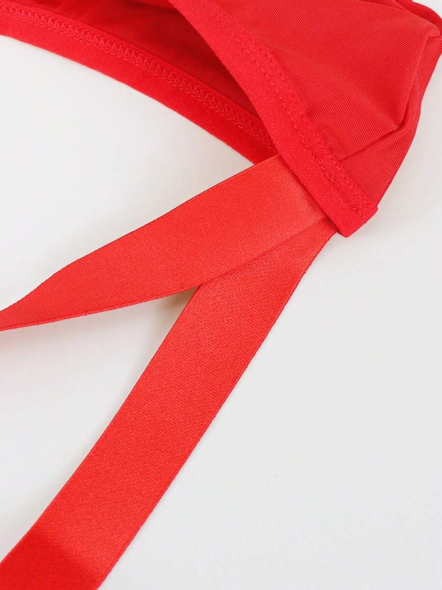 Red men's low-rise jockstrap underwear featuring criss-cross cut-out details in medium stretch knitted fabric.