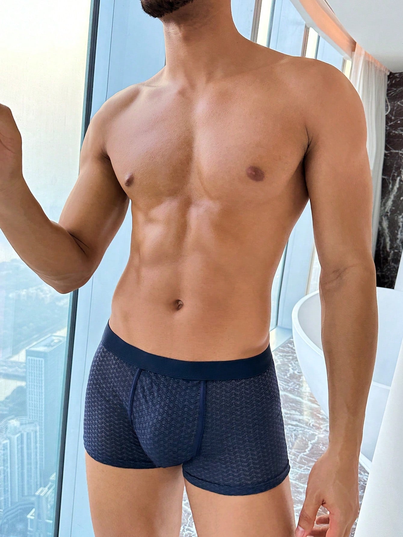 Men's solid color boxer shorts underwear with contrast mesh detail, high-rise waist, and medium-stretch knitted fabric in a minimalist style for casual daily wear.