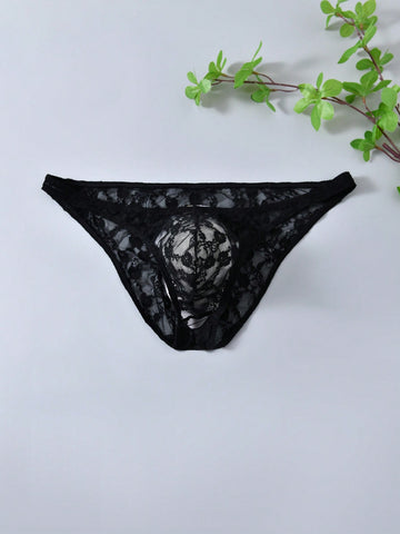 Men's black lace thong underwear with low rise fit, contrast lace detail, and T-back design in medium-stretch polyester elastane fabric.