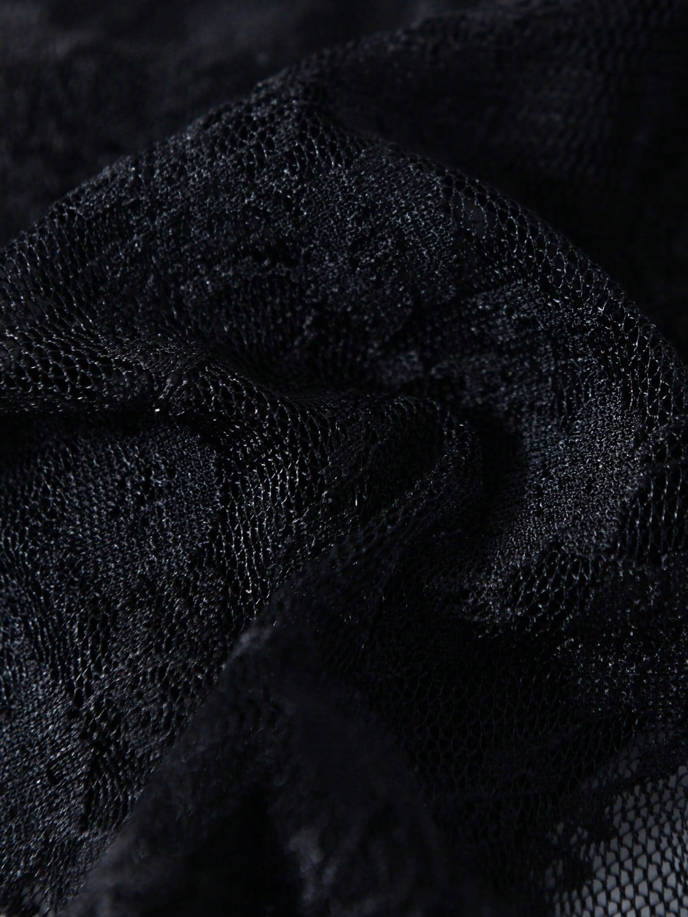 Men's black lace thong underwear with low rise fit, contrast lace detail, and T-back design in medium-stretch polyester elastane fabric.