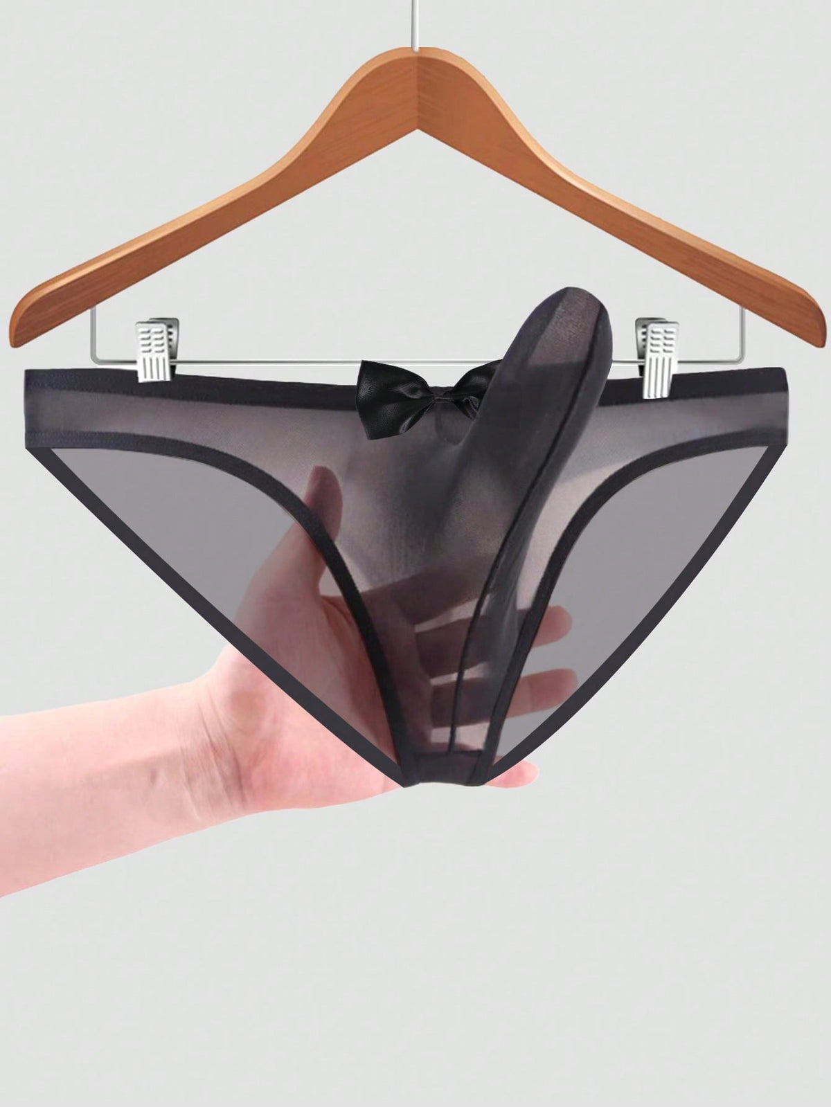 Men's sheer mesh triangle briefs in solid color featuring a mid-rise waist and breathable knitted stretch fabric.