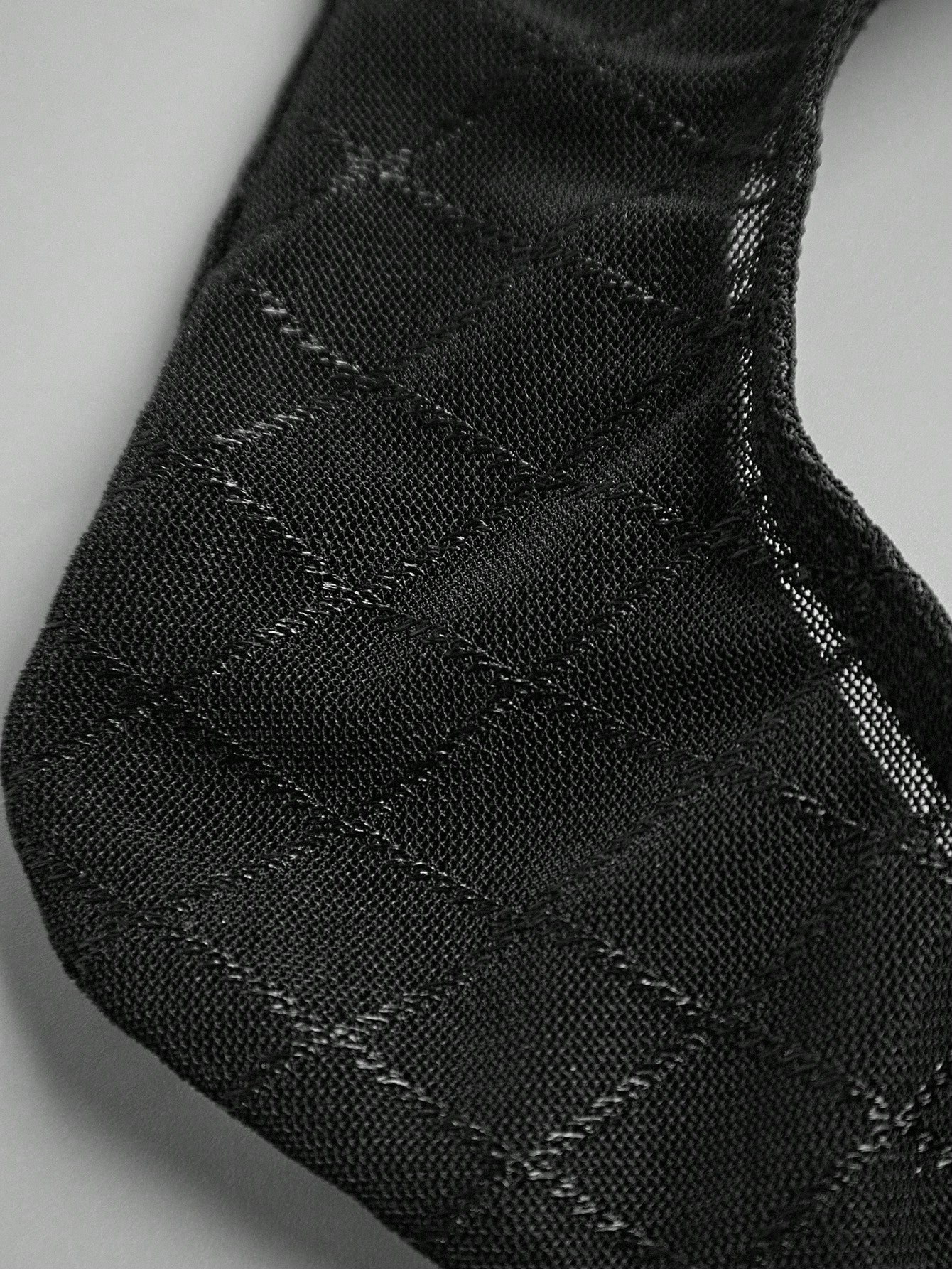 Men's sheer mesh thong underwear in multicolor with low-rise cut, plaid and random print pattern, and high-stretch polyamide elastane fabric.