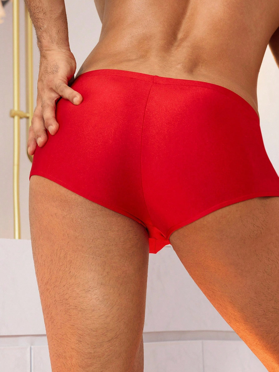 Men's red low rise boxer shorts with zipper fly detail, U-pouch front, colorblock pattern, and medium-stretch knitted fabric.