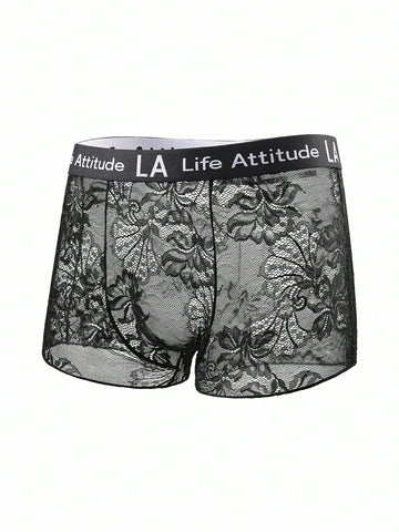 Men's black low rise lace briefs with letter waistband, semi-sheer fabric and medium stretch design.