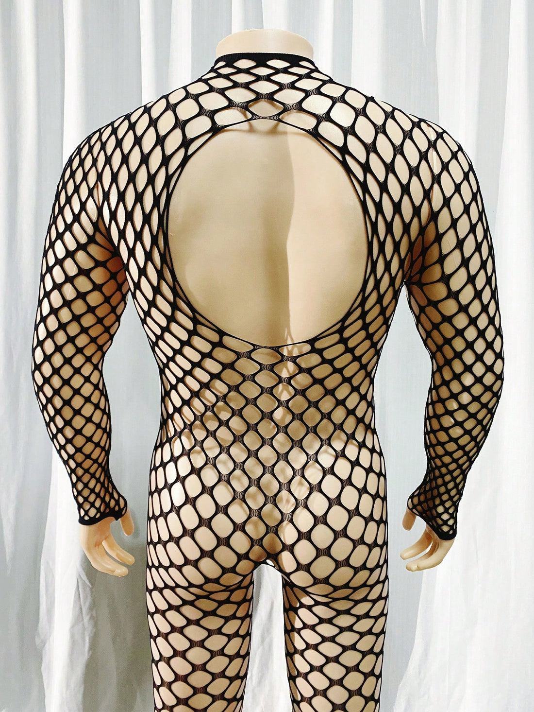 Black men's sheer bodystocking bodysuit with cut-out detail, all over print, short length, and high stretch polyamide elastane fabric.