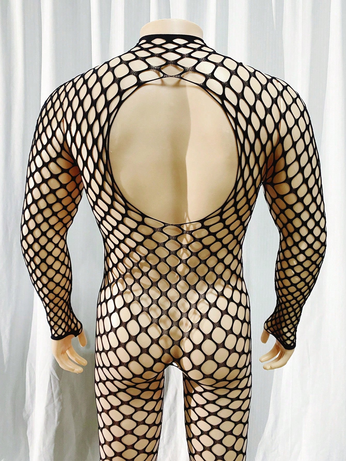 Black men's sheer bodystocking bodysuit with cut-out detail, all over print, short length, and high stretch polyamide elastane fabric.