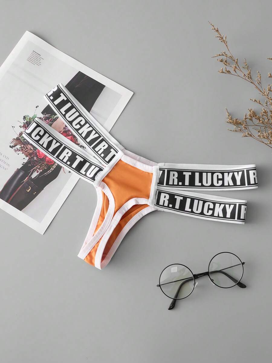 Black low-rise men's thong underwear featuring a belted waist detail and letter pattern on knitted fabric.