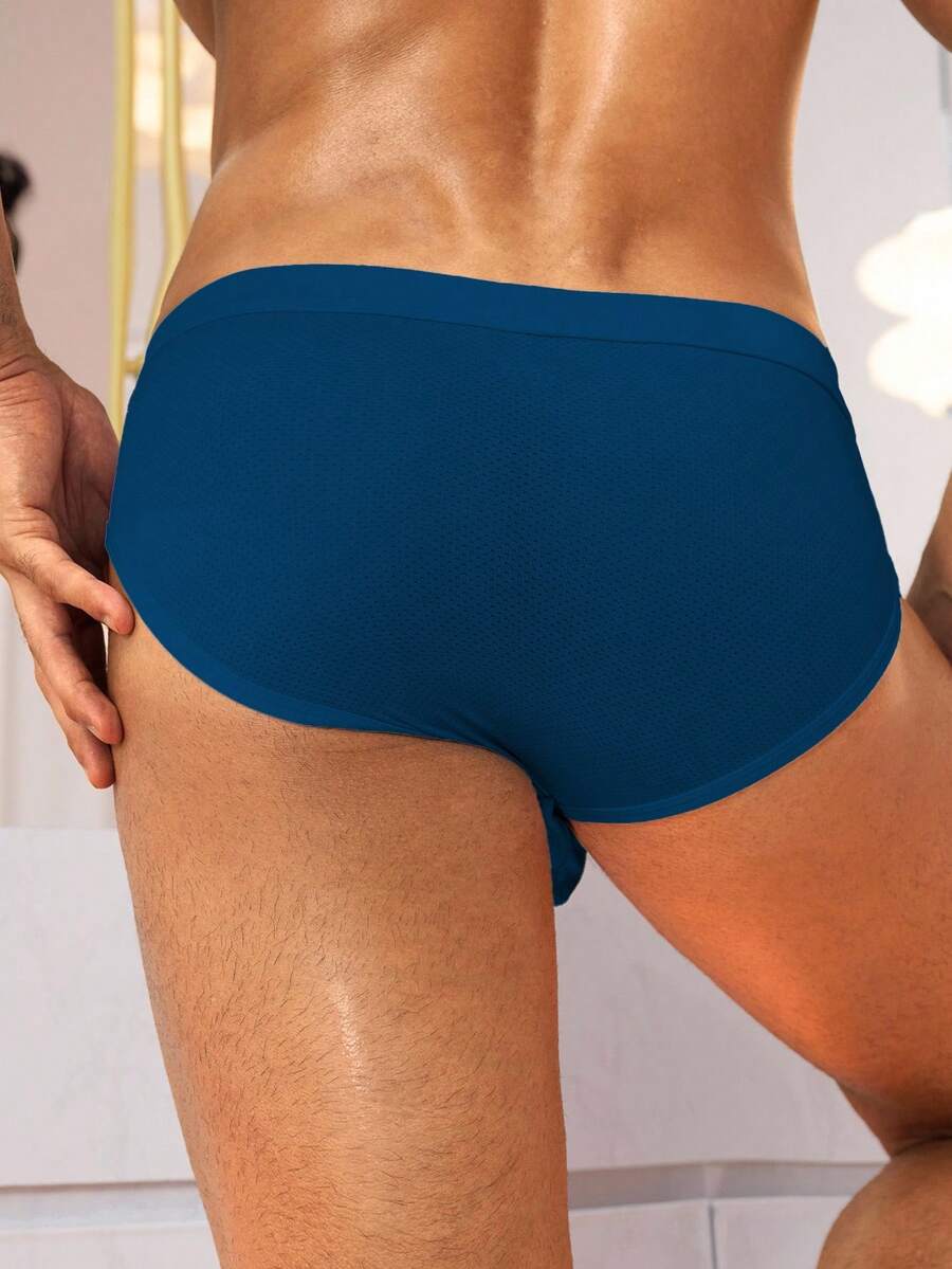 Black low rise knitted men's briefs featuring a plain pattern and elastic fabric.
