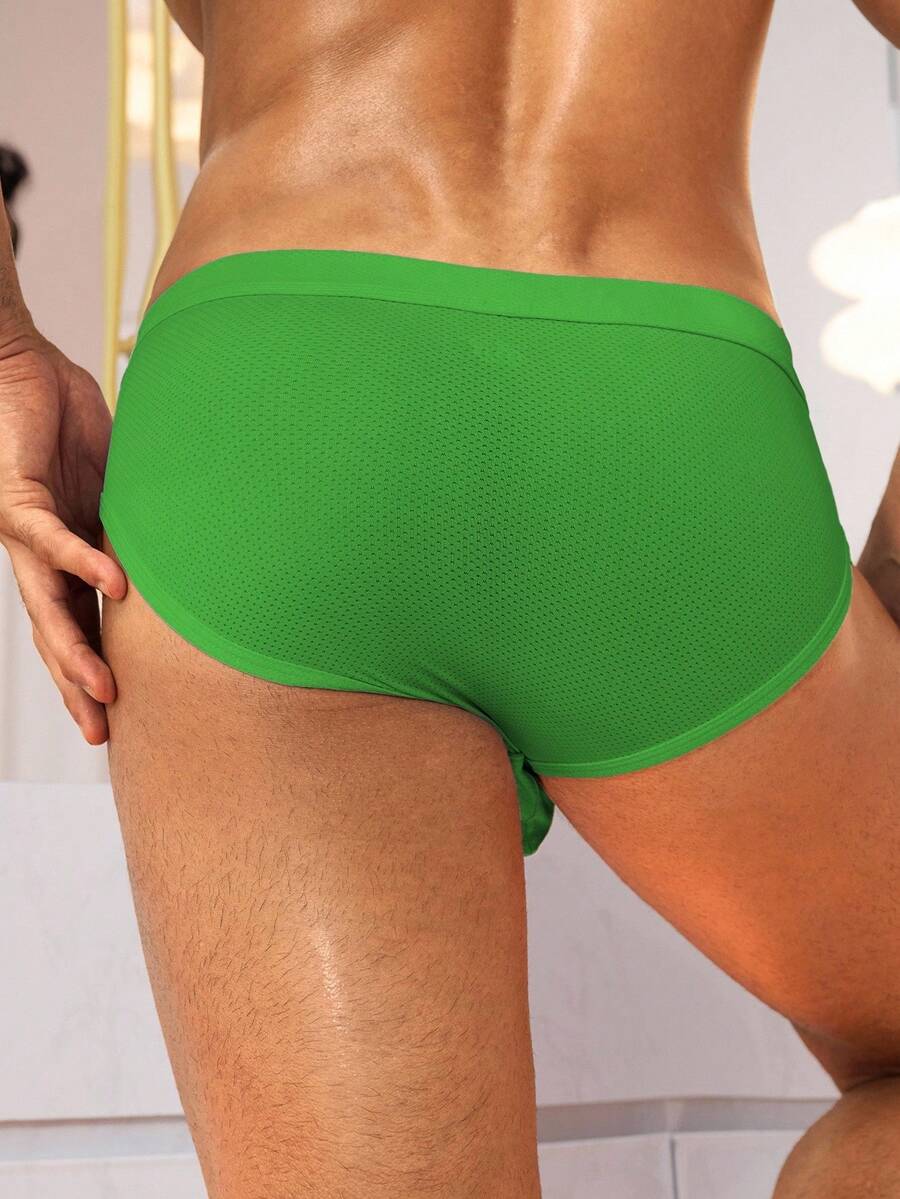 Black low rise knitted men's briefs featuring a plain pattern and elastic fabric.