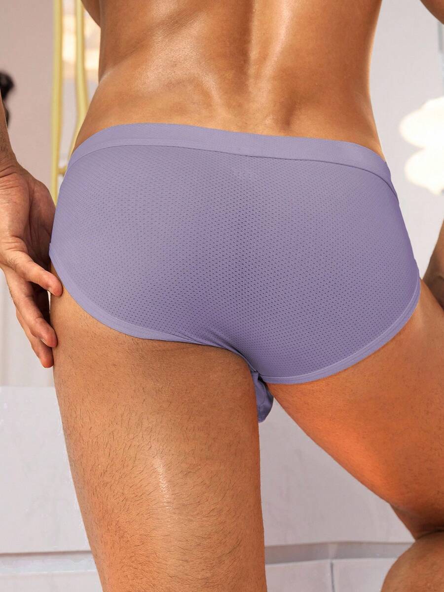 Black low rise knitted men's briefs featuring a plain pattern and elastic fabric.