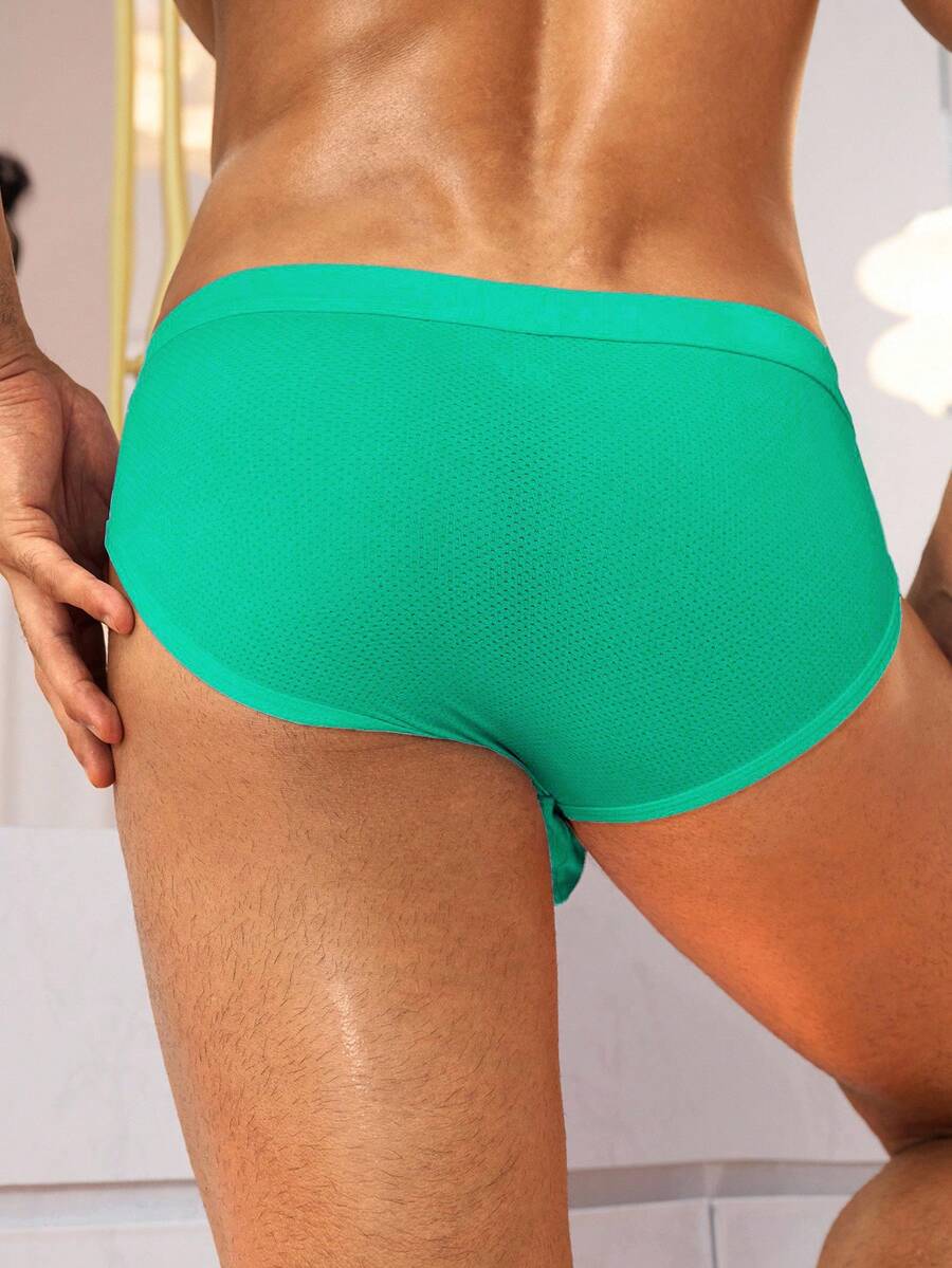 Black low rise knitted men's briefs featuring a plain pattern and elastic fabric.