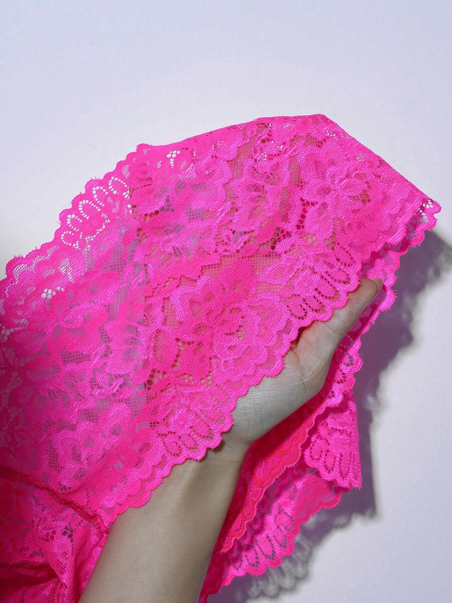 Hot pink semi-sheer low rise lace briefs for men featuring bow and contrast lace details.