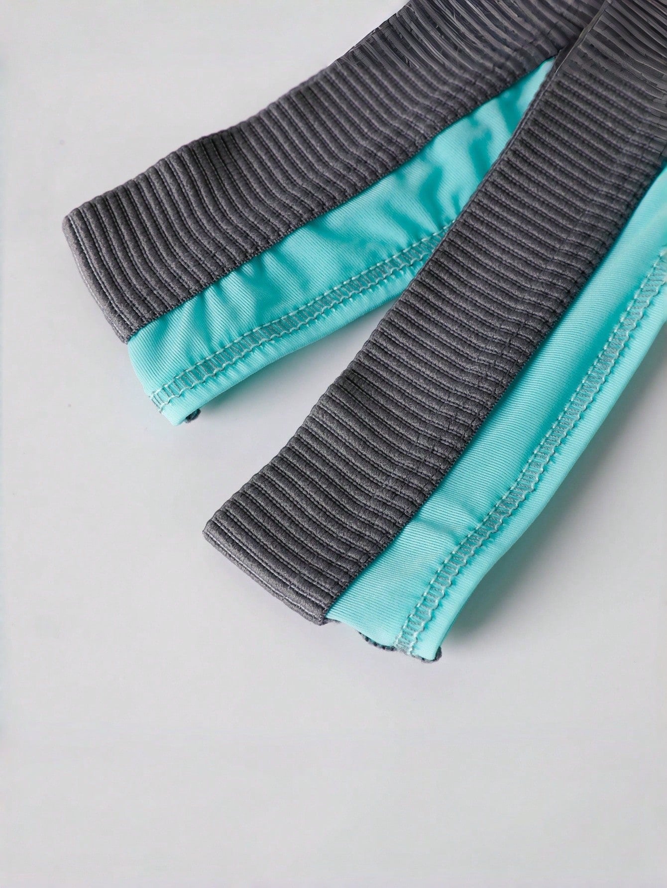 Blue men's thong underwear with contrast binding and a low-rise design in medium-stretch polyamide elastane fabric.