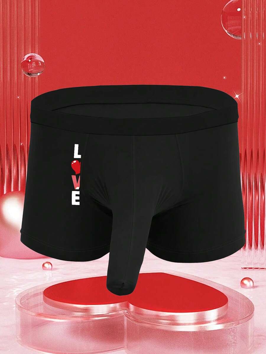 Black men's elephant pouch boxer shorts featuring letter print design and high-stretch fabric.
