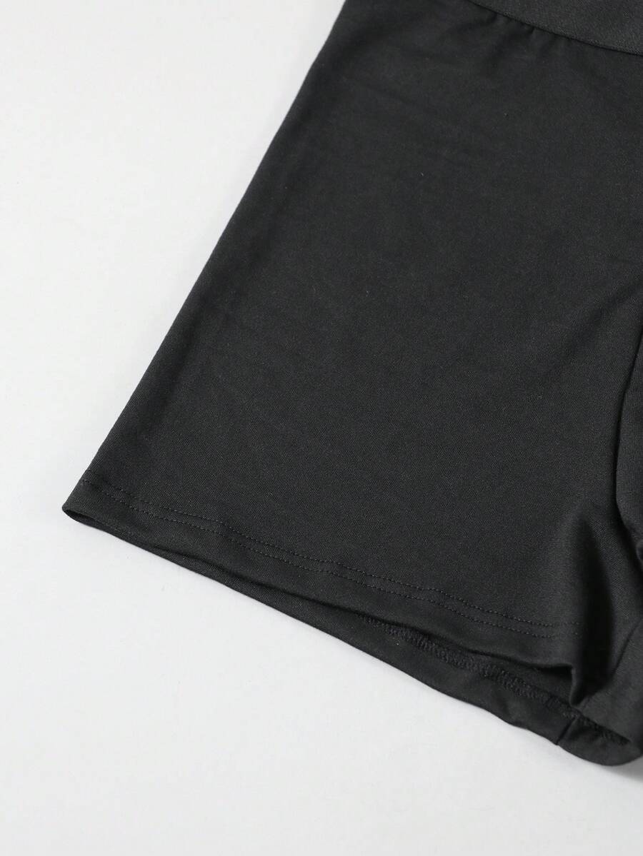 Black men's elephant pouch boxer shorts featuring letter print design and high-stretch fabric.