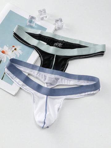 Set of two men's low-rise thong underwear featuring multicolor plant print and contrast waistband.