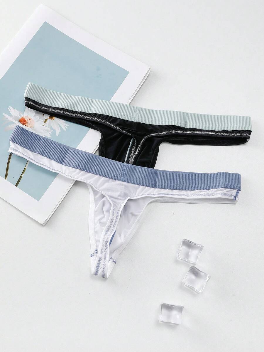 Set of two men's low-rise thong underwear featuring multicolor plant print and contrast waistband.