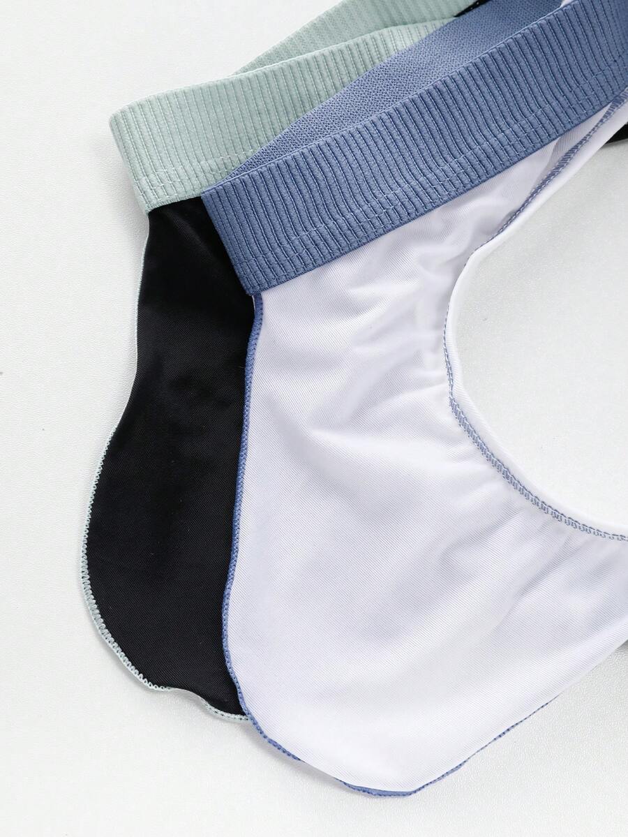 Set of two men's low-rise thong underwear featuring multicolor plant print and contrast waistband.