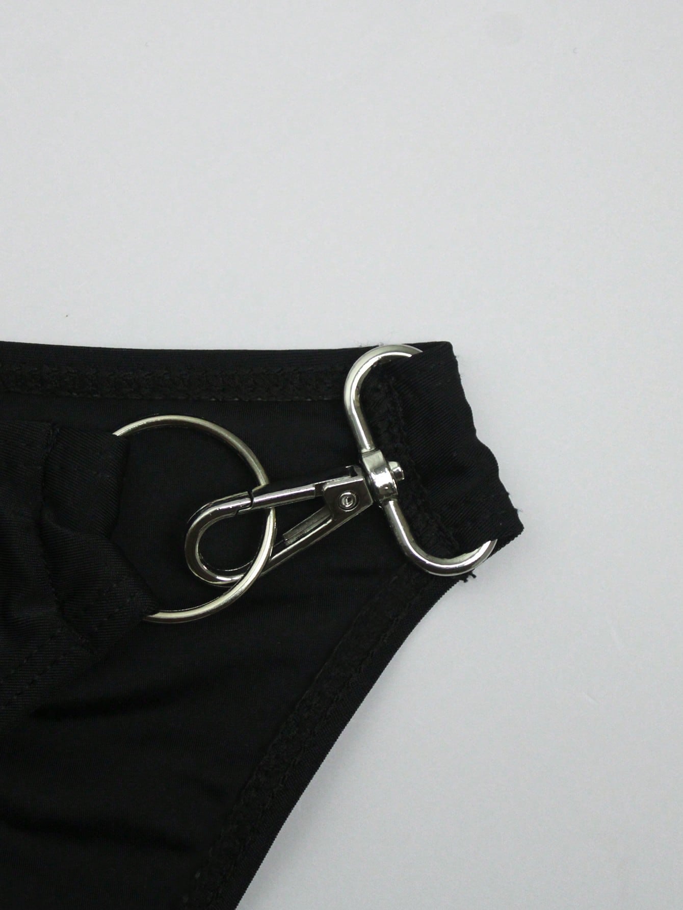 Men's solid swim briefs with O-ring detail, high waist, short racer cut, and high-stretch polyamide elastane fabric.