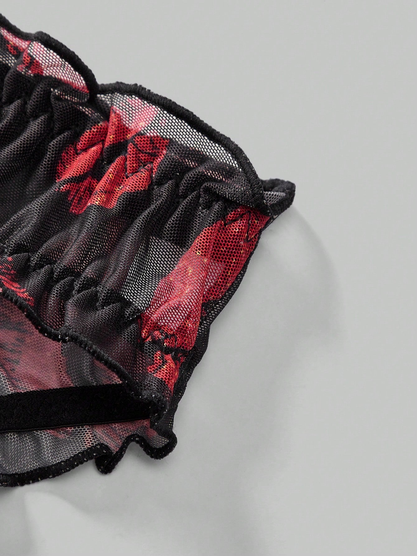 Men's low rise mesh briefs lingerie with random print design, high-stretch fabric, and unlined construction.